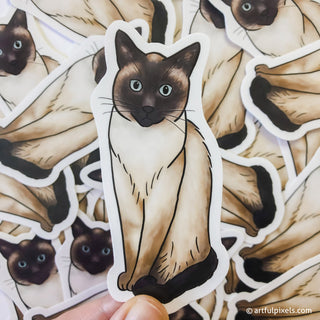 Collage of Siamese cat stickers with one held closer in foreground